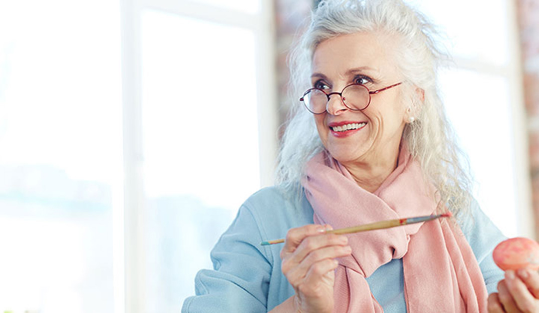 woman painting an egg