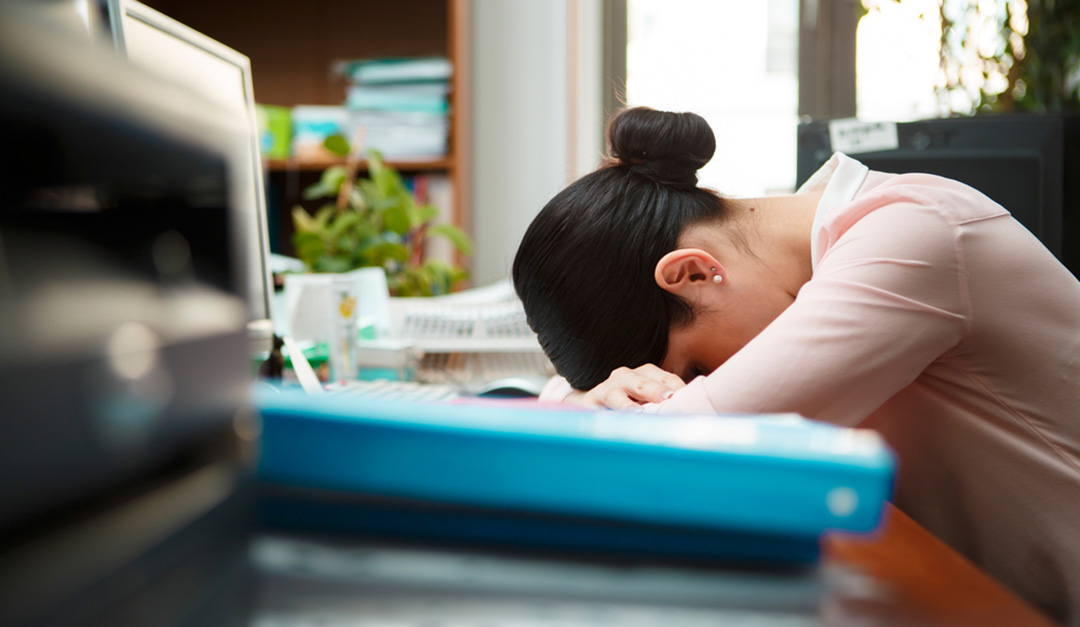 woman sleeping on desk