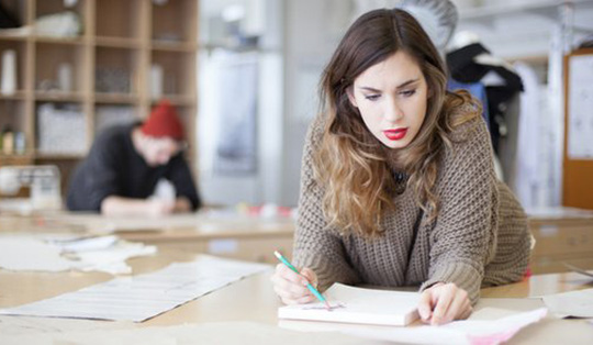 girl writing on a notebook