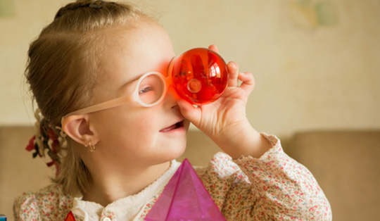 Child holds a ball