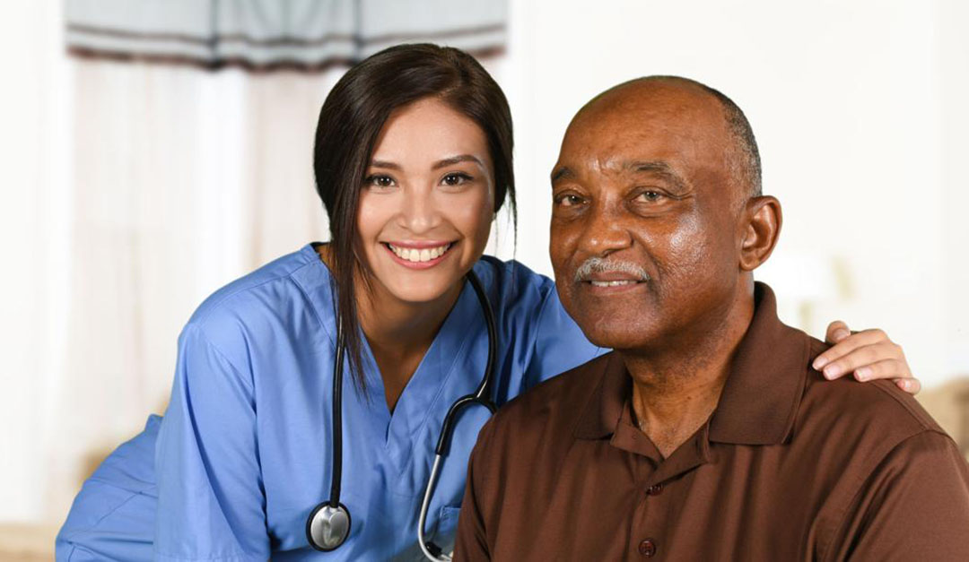 Nurse one hand on senior's shoulder