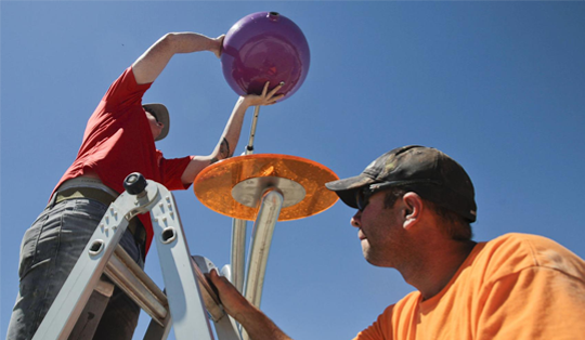 Man assisting a woman in the ladder