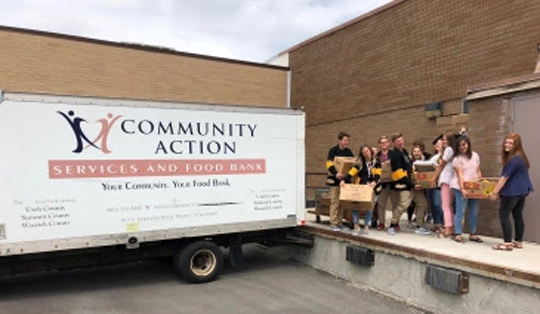 Employees carrying boxes together