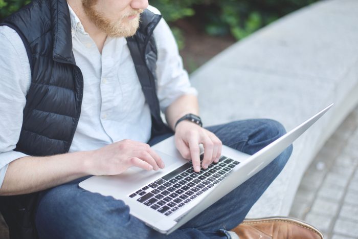 Man typing on a laptop