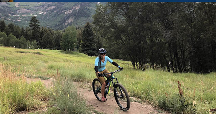 woman riding on a bike on the mountain