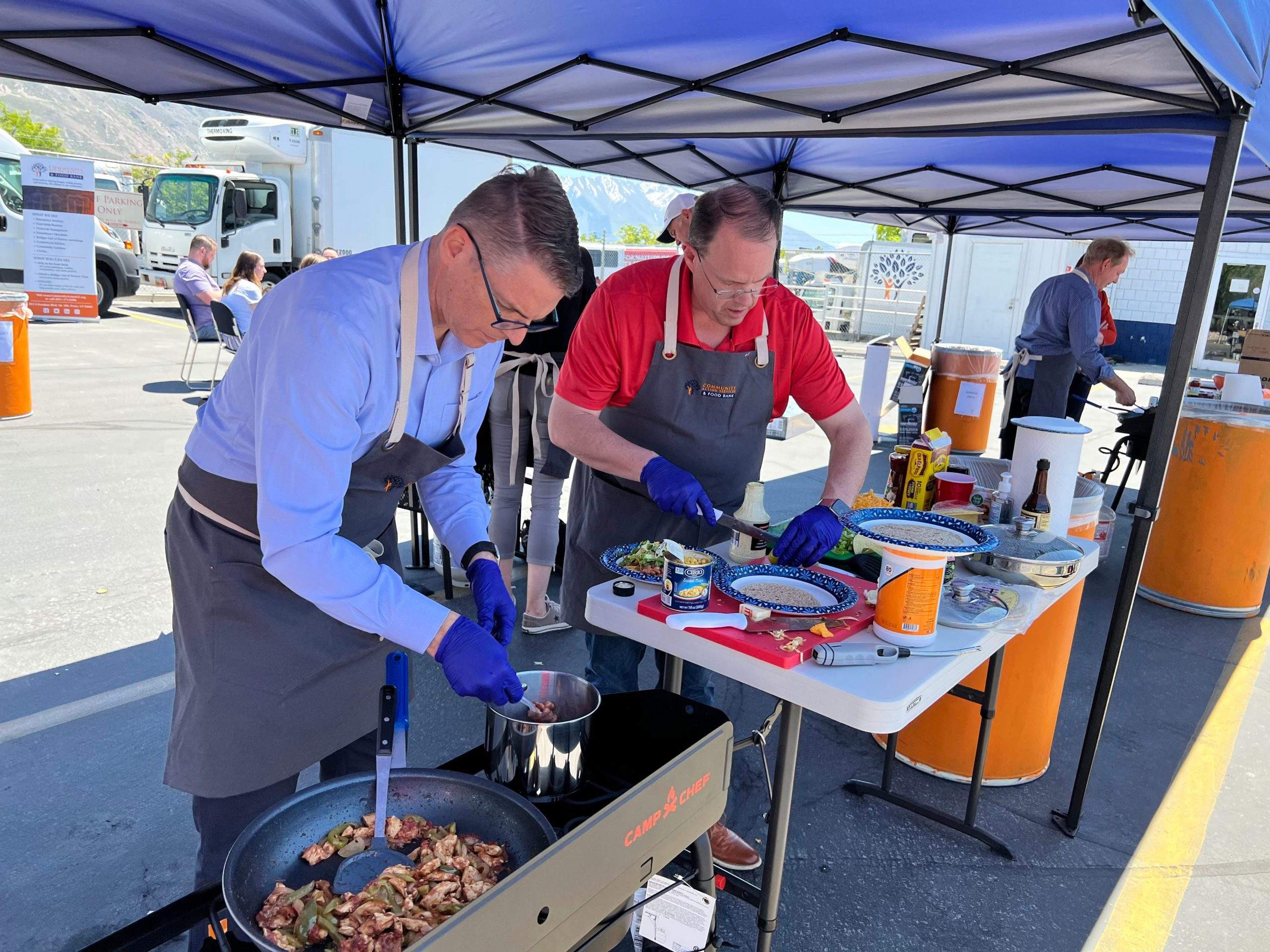 Two man making fajita and taco