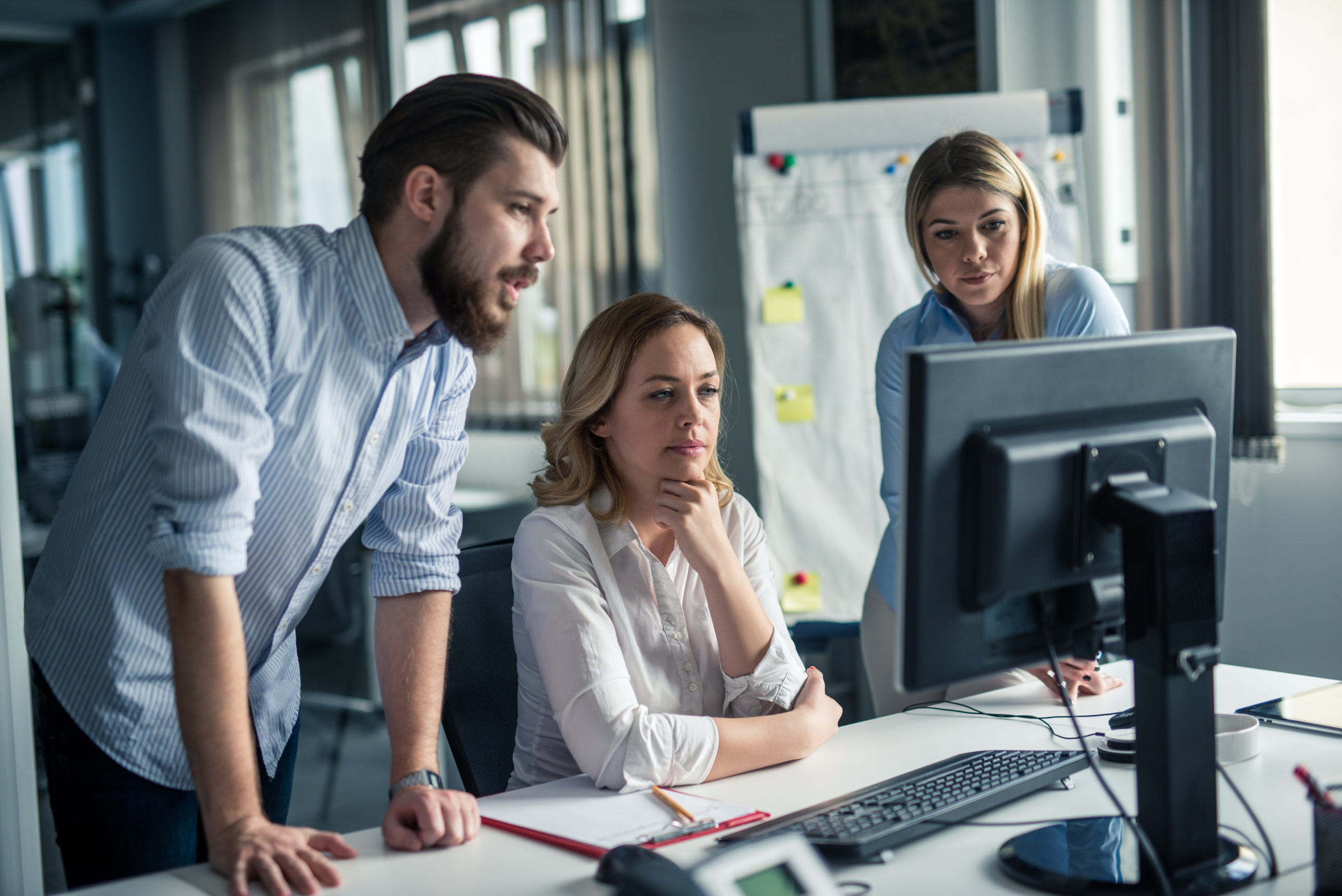 Team of Business people, working on a computer together